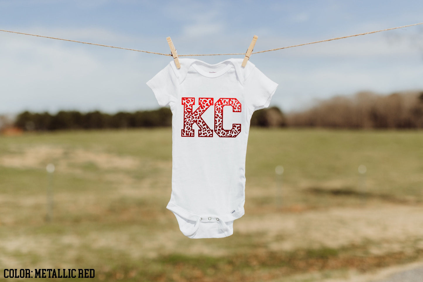 a white bodysuit hanging on a clothes line
