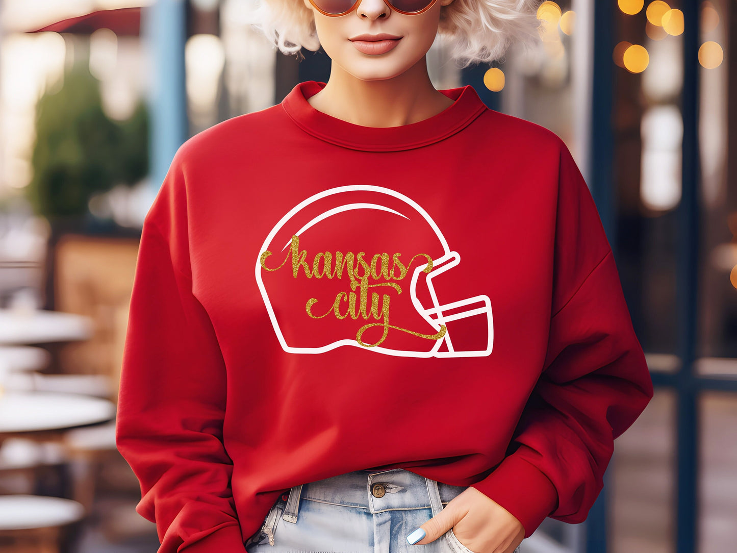 a woman wearing a red sweatshirt with a football helmet on it kansas city
