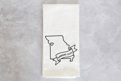 a tea towel with the state of missouri printed on it a heart at kansas city